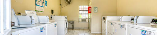A laundromat with rows of washers and dryers.