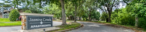 The image shows a street view of Jasmine Creek Apartments.