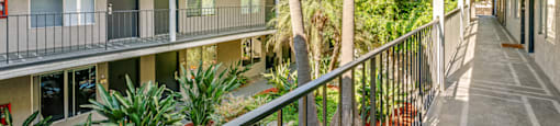 a balcony view of a building with palm trees