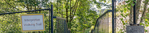 a gate with a sign that reads interpretive walking trail