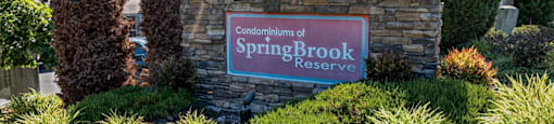 entrance monument sign on stone structure reading Springbrook Reserve