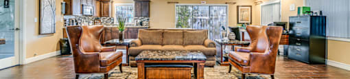 A living room with a brown sofa, two chairs, and a coffee table. at Westminster Chase Apartments, Tampa, 33616