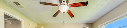 A room with a ceiling fan and a window overlooking a building at Westminster Chase Apartments, Florida, 33616