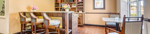 a dining room with a table and chairs and a bar