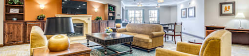 a living room with couches and chairs and a fireplace