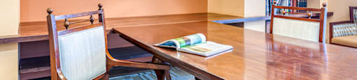 a dining room with a wooden table and chairs