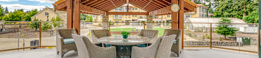 covered patio with table and chairs overlooking courtyard