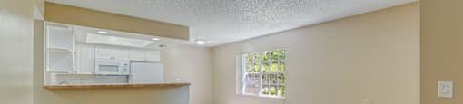 A room with a ceiling fan and wooden flooring. at Green Oaks Apartments, Tampa, FL, 33616