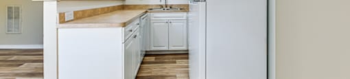 A kitchen with white appliances and cabinets at Green Oaks Apartments, Tampa, 33616