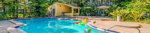 A small pool with a yellow ball in it.