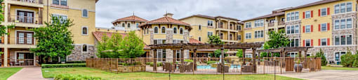 Apartment complex with a grassy area in front.
