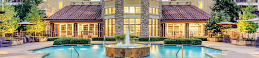 A large house with a pool in front.