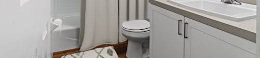 Brightly lit bathroom at Rosemont Square Apartments, Massachusetts, 02368