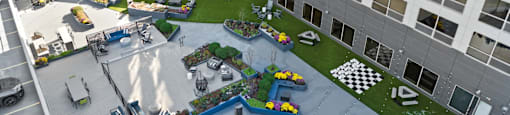 Rooftop lounge with grills, seating, and games at Presidential Towers in Chicago, IL