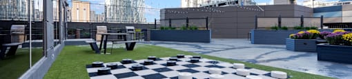 a chess board on a lawn on the roof of a building at Presidential Towers, Illinois
