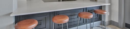 a kitchen with stools and a counter with a sink and a tv at Sladestone Shadow Creek, Pearland, TX, 77584