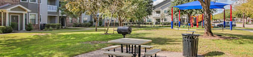 our apartments have a picnic table and a playground at Sladestone Shadow Creek, Pearland, TX, 77584