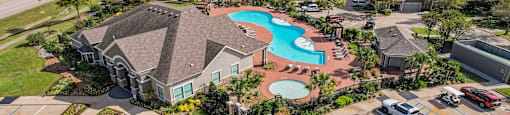 an aerial view of a neighborhood with a swimming pool and houses at Sladestone Shadow Creek, Texas