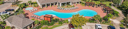 an aerial view of a swimming pool in a community with houses at Sladestone Shadow Creek, Pearland
