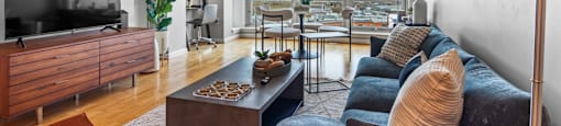 Living room flooded with natural light at The Amelia Apartments in Quincy, MA