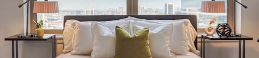 a bedroom with a large bed in front of a window at Presidential Towers in Chicago, Illinois