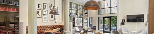 a large living room with a dining room table and chairs