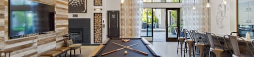 Common Area with Pool Table, Kitchen and Seating at Aventine Apartments in Hercules, CA 94547