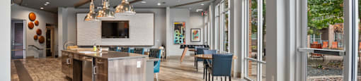 a kitchen with a large island and a dining room with a table and chairs at South Side Flats, Dallas