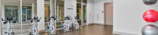 the gym with treadmills and exercise balls at the belgard apartments at South Side Flats, Dallas, 75215