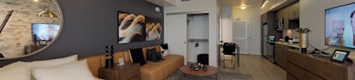 a bedroom with a bed and a living room with a couch and a tv at OLiVE DTLA in CA 90015