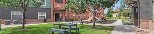 our apartments have a spacious courtyard with picnic tables at Apartments at Switchback on Platte Apartments, Littleton