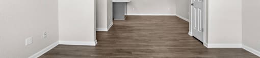 a renovated living room with white walls and wood flooring at Switchback on Platte Apartments, Colorado, 80120