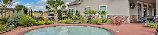 a small pool in a backyard in front of a house at Sladestone Shadow Creek, Texas, 77584