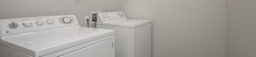 an empty laundry room with white appliances and a washer and dryer at Sladestone Shadow Creek, Pearland, TX, 77584
