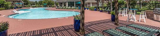 a large swimming pool with lounge chairs and a wooden pavilion at Sladestone Shadow Creek, Pearland, TX, 77584