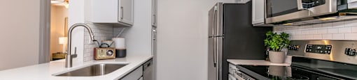 an empty kitchen with white cabinets and stainless steel appliances at Briarcliff Apartments, Atlanta, GA, 30329