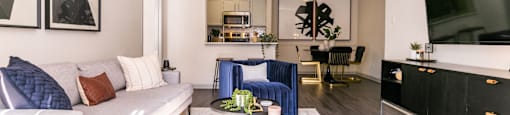 a living room with a white couch and a tv at Briarcliff Apartments, Atlanta, GA