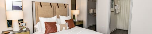 a bedroom with a large bed and a ceiling fan at Briarcliff Apartments, Atlanta