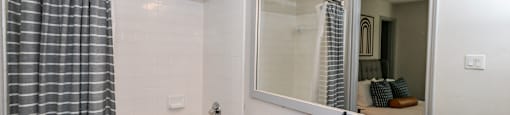 a bathroom with a sink and a mirror and a tub at Briarcliff Apartments, Georgia, 30329