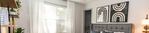 a bedroom with a large bed and a ceiling fan at Briarcliff Apartments in North Druid Hills, GA