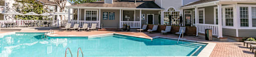 a large swimming pool with a house in the background at Briarcliff Apartments, Georgia