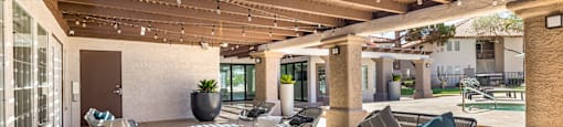 a patio with couches and tables and chairs