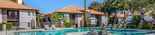 our apartments have a resort style pool with lounge chairs and trees