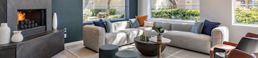 a living room with couches and chairs and a fireplace at Mirasol Apartments, Las Vegas, 89119