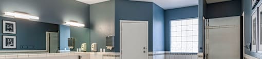 a large bathroom with a tub and a sink and a door at Mirasol Apartments, Las Vegas