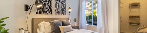 a bedroom with a bed and a window at Mirasol Apartments, Las Vegas, Nevada