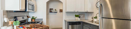 a kitchen with stainless steel appliances and a counter top with a basket at Mirasol Apartments, Las Vegas, NV 89119