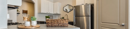 a kitchen with a counter top and a stainless steel refrigerator at Mirasol Apartments, Las Vegas, NV