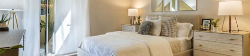 a bedroom with a bed and a door to a balcony at Mirasol Apartments, Las Vegas, 89119