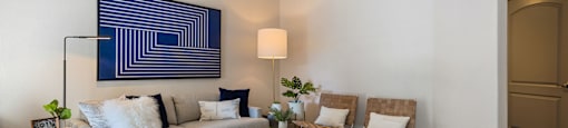a living room with a couch and chairs and a rug at Mirasol Apartments, Nevada
